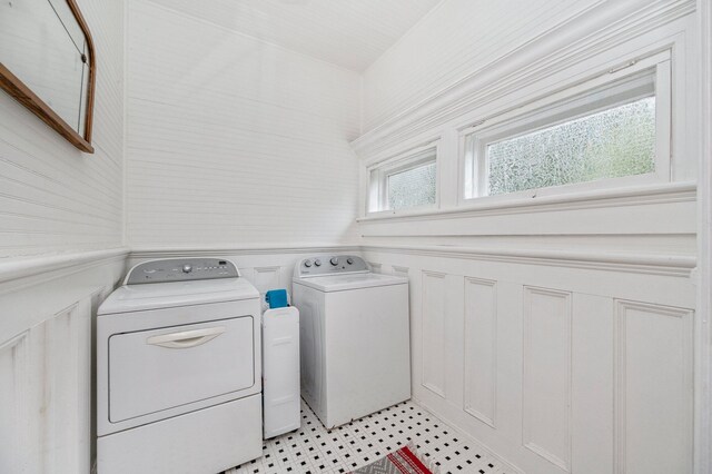 clothes washing area featuring a healthy amount of sunlight and washer and clothes dryer