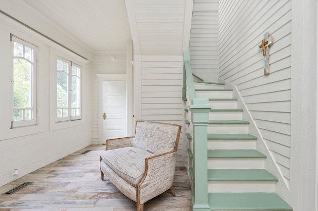 staircase with wood walls and hardwood / wood-style floors