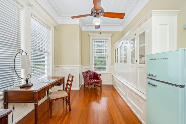 office space featuring light wood-type flooring, crown molding, and ceiling fan