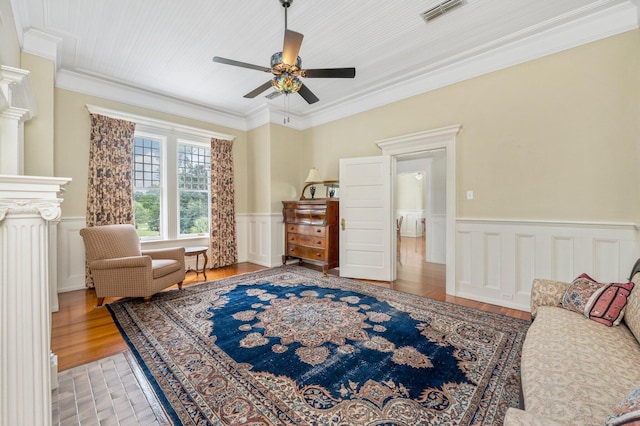 interior space featuring ornamental molding, light hardwood / wood-style floors, and ceiling fan