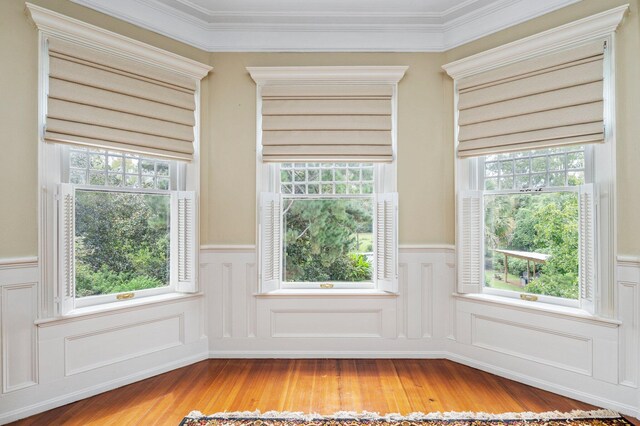 entryway featuring wood-type flooring and ornamental molding