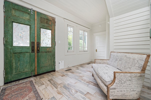 entrance foyer featuring wood walls and wood-type flooring