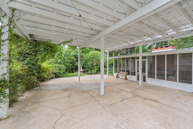 view of patio featuring a sunroom