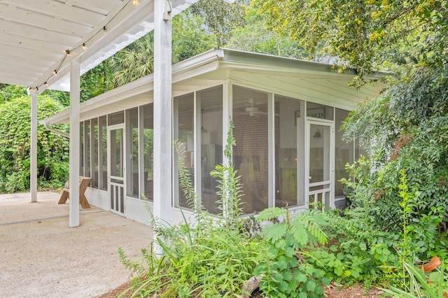 view of side of property with a sunroom