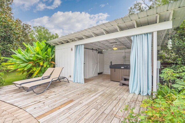 wooden deck featuring a hot tub