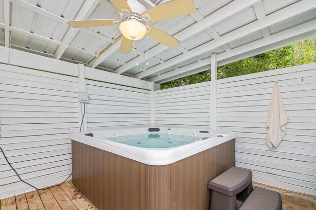 sunroom featuring ceiling fan, vaulted ceiling, and a hot tub