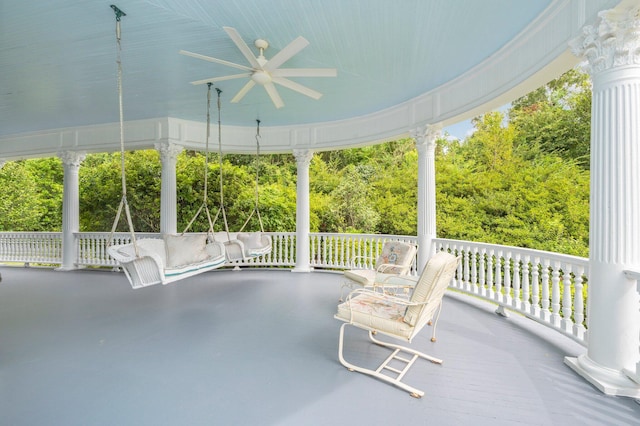 unfurnished sunroom featuring ornate columns