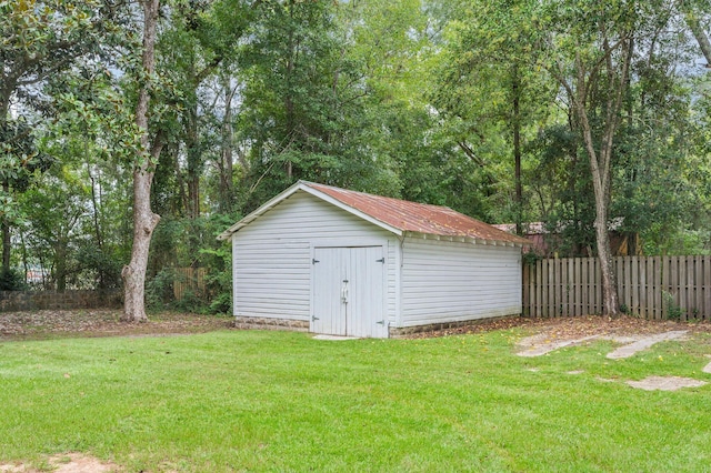 view of outbuilding with a yard