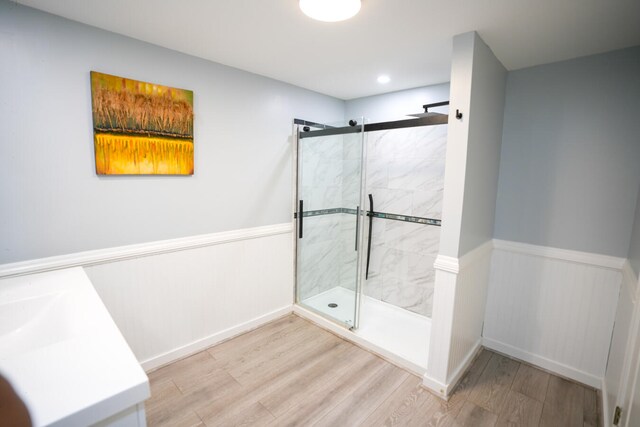 bathroom featuring an enclosed shower and wood-type flooring