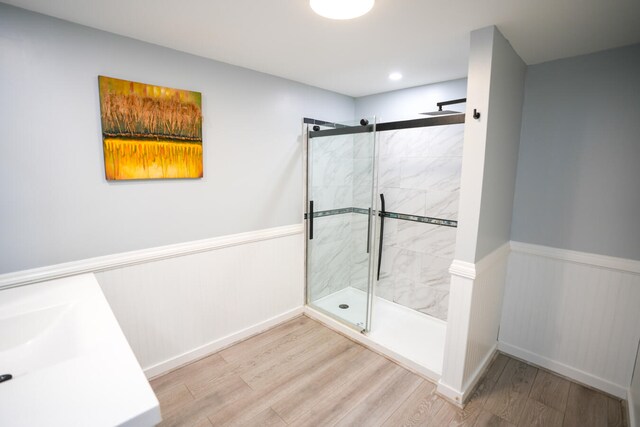 bathroom with walk in shower and wood-type flooring