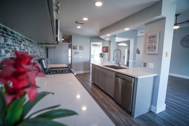 kitchen featuring appliances with stainless steel finishes, gray cabinetry, sink, and dark hardwood / wood-style floors