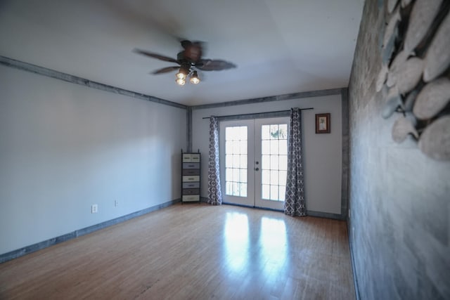 unfurnished room with french doors, light hardwood / wood-style flooring, and ceiling fan