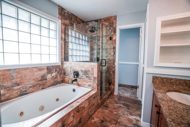 bathroom featuring separate shower and tub and vanity