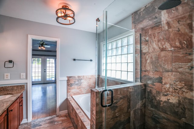 bathroom with ceiling fan, vanity, independent shower and bath, french doors, and hardwood / wood-style flooring