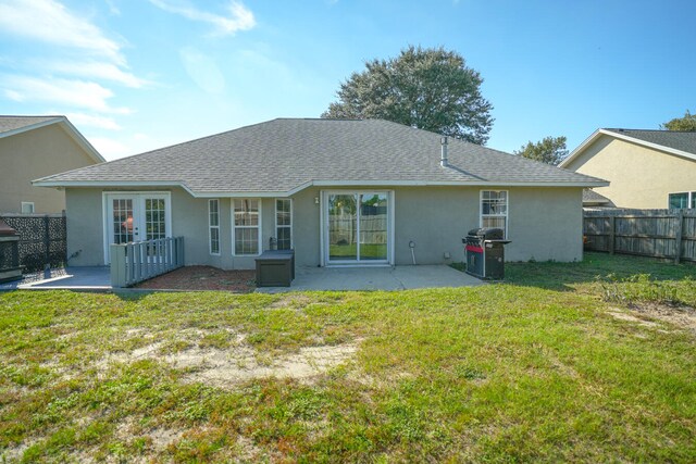 rear view of house featuring a yard and a patio area