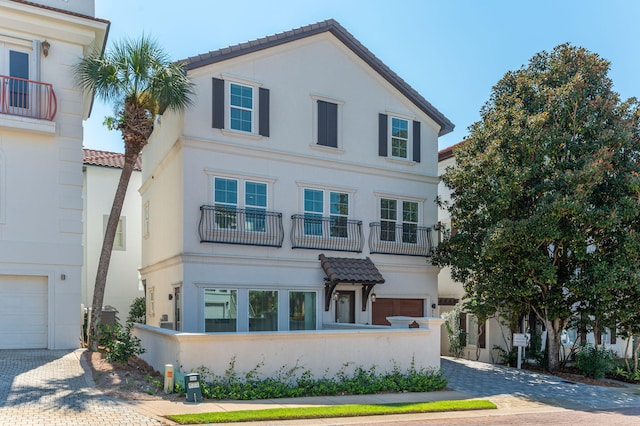 view of front of home featuring a balcony and a garage