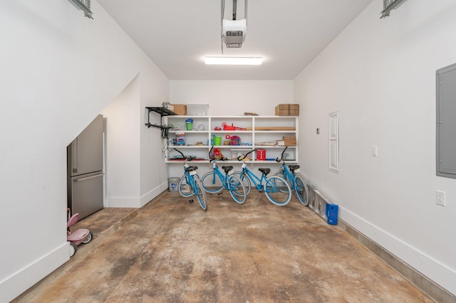 garage featuring stainless steel fridge and a garage door opener