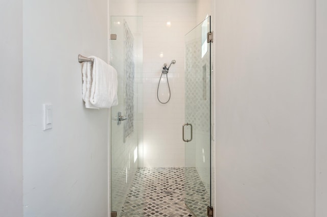 bathroom with a shower with shower door