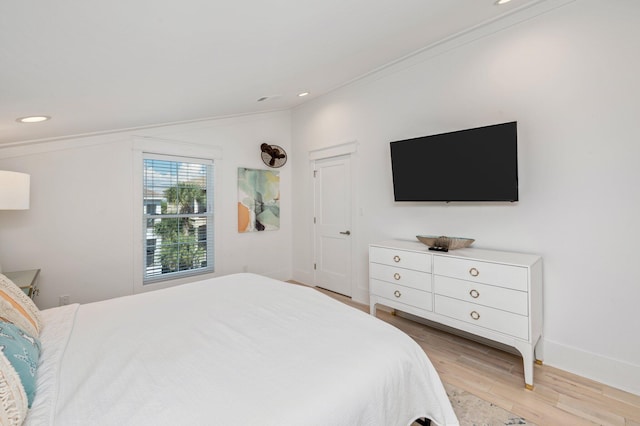 bedroom featuring light hardwood / wood-style flooring and ornamental molding