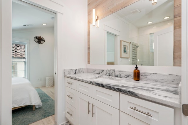 4795 Ocean Blvd, Destin, FL 32541 - full bathroom with vanity, recessed lighting, a tile shower, wood finished floors, and ornamental molding