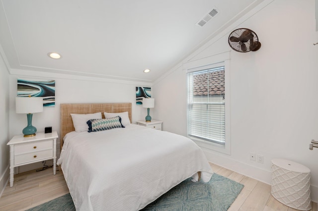 bedroom with light hardwood / wood-style flooring and ornamental molding