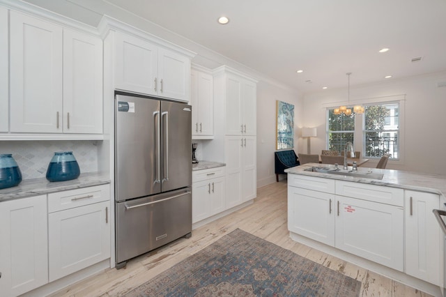 4795 Ocean Blvd, Destin, FL 32541 - kitchen featuring high end fridge, white cabinetry, a chandelier, light wood-type flooring, and light stone counters