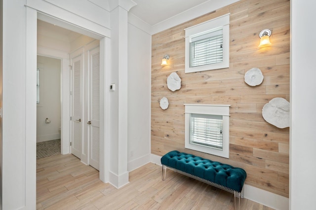 corridor with wood-type flooring and wooden walls