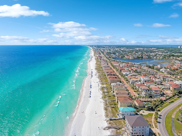 drone / aerial view featuring a water view and a view of the beach