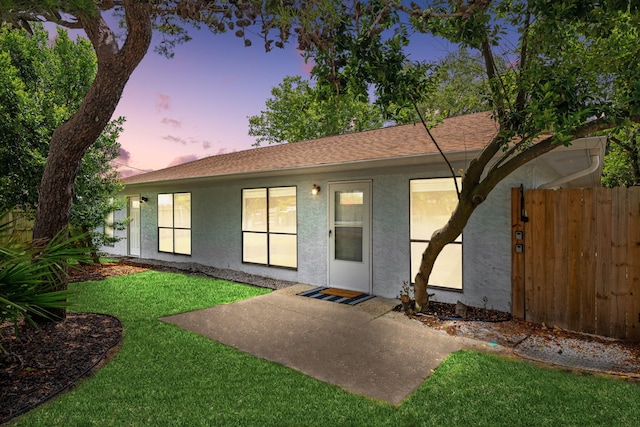 single story home featuring a yard and a patio