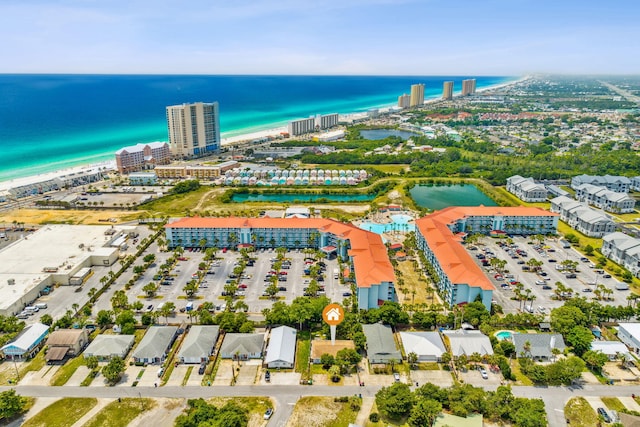 drone / aerial view with a beach view and a water view