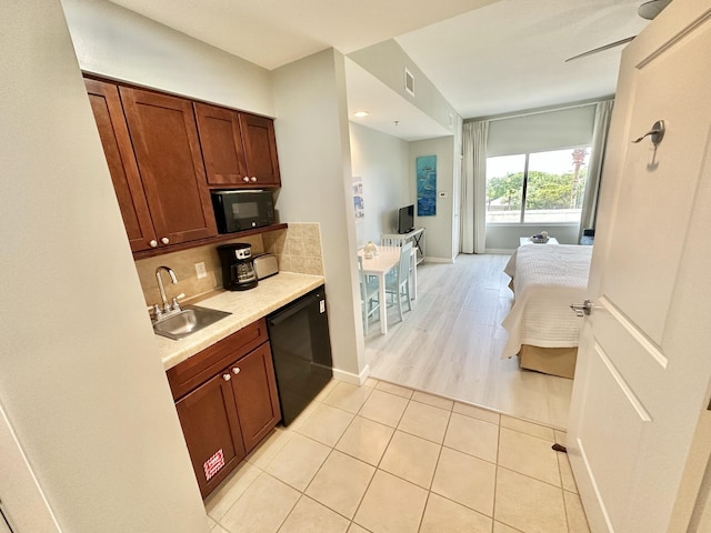 5002 S Sandestin Blvd # 6322, Miramar Beach, FL 32550 - kitchen featuring black appliances, light countertops, tasteful backsplash, light tile patterned floors, and brown cabinetry