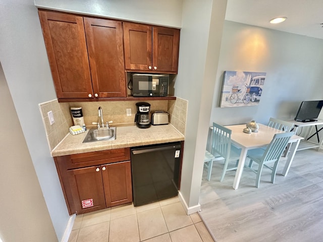 5002 S Sandestin Blvd # 6322, Miramar Beach, FL 32550 - kitchen featuring black appliances, light countertops, decorative backsplash, and brown cabinetry