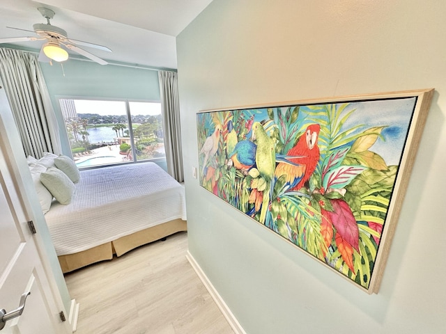 5002 S Sandestin Blvd # 6322, Miramar Beach, FL 32550 - bedroom with wood finished floors, a water view, and ceiling fan