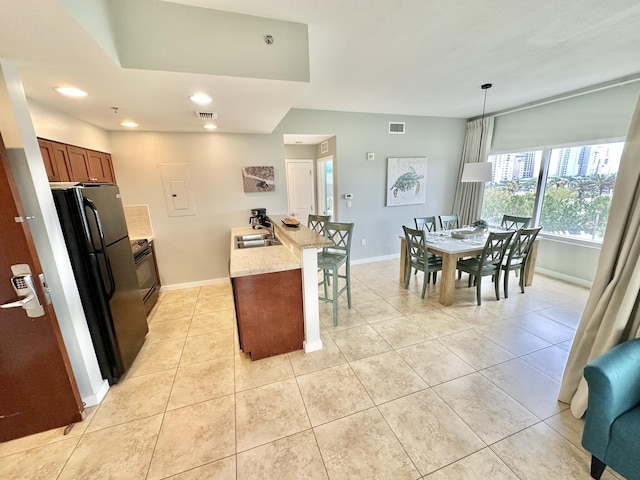 5002 S Sandestin Blvd # 6322, Miramar Beach, FL 32550 - kitchen with black appliances, a breakfast bar area, light tile patterned floors, recessed lighting, and light stone counters