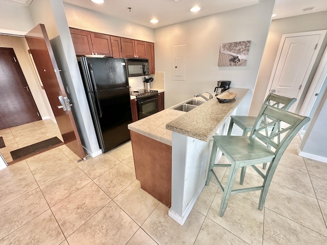 5002 S Sandestin Blvd # 6322, Miramar Beach, FL 32550 - kitchen featuring black appliances, recessed lighting, a peninsula, light countertops, and light tile patterned floors