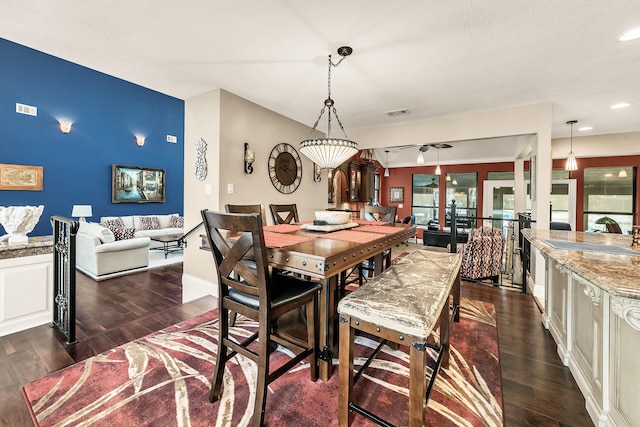 dining space featuring dark hardwood / wood-style floors and sink