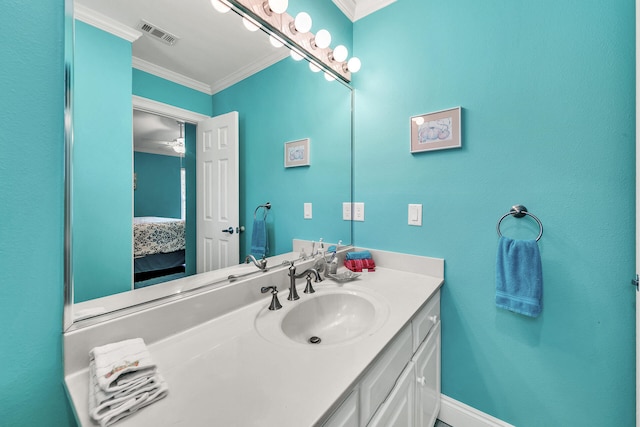 bathroom featuring ornamental molding, vanity, and ceiling fan