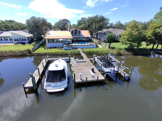 view of dock featuring a lawn and a water view