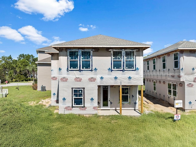 back of property with central AC, a patio, and a lawn