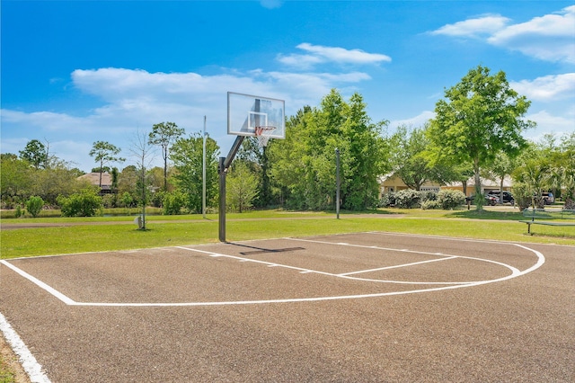 view of sport court with a yard