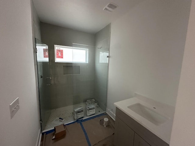 bathroom with vanity and walk in shower