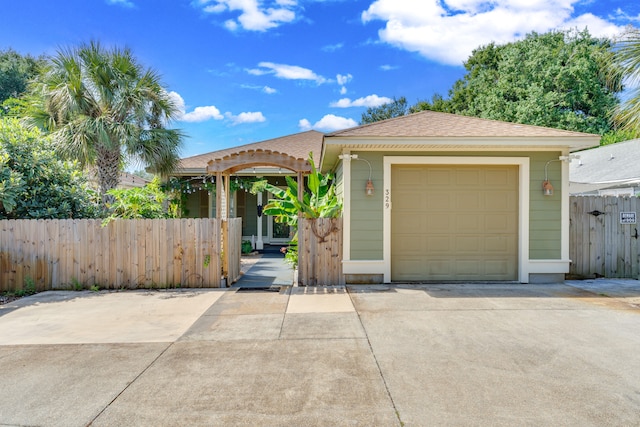 view of front of home with a pergola and a garage