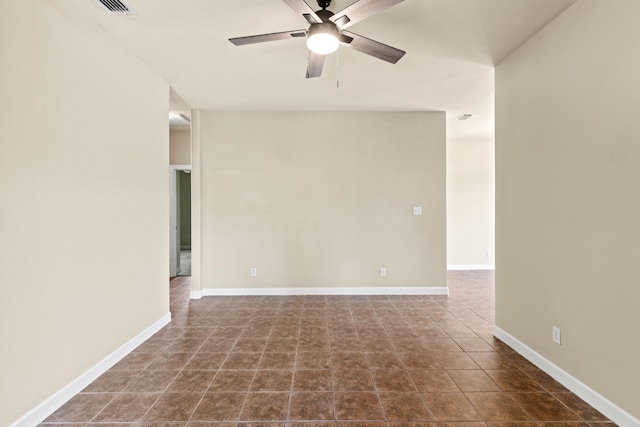 tiled spare room with ceiling fan