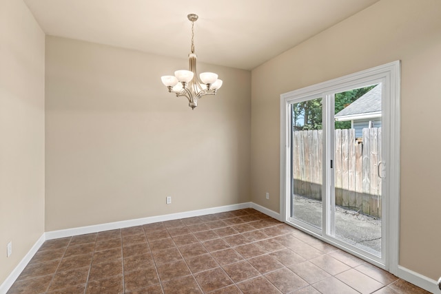 unfurnished room featuring tile patterned flooring and a chandelier