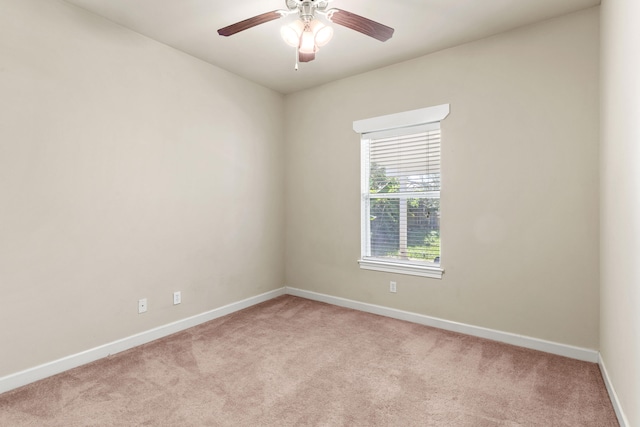 spare room with light carpet and ceiling fan