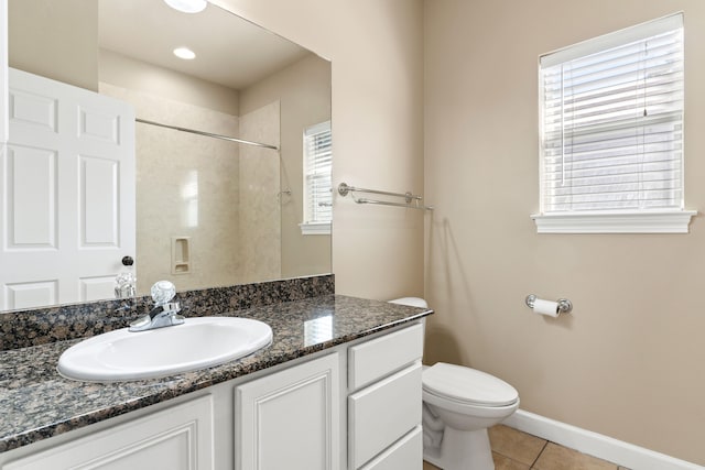 bathroom featuring tile patterned flooring, plenty of natural light, vanity, and toilet