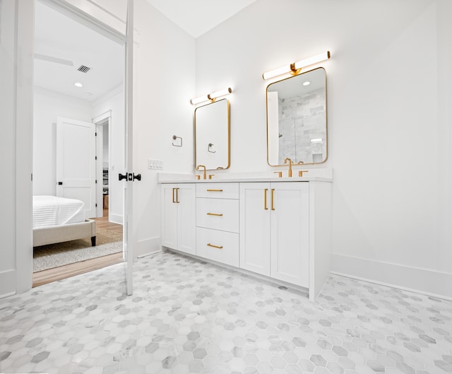 bathroom featuring a shower and vanity