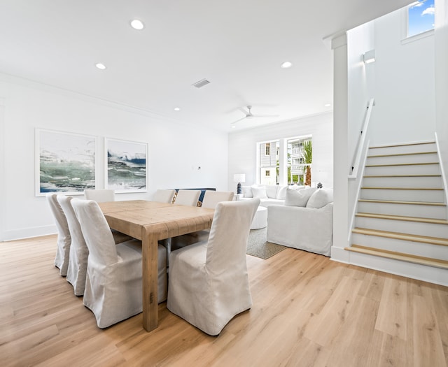 dining area featuring ceiling fan, light wood-type flooring, and crown molding