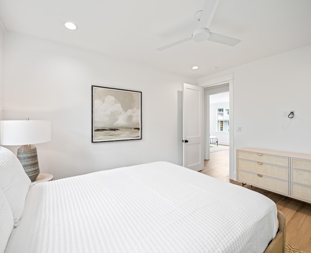 bedroom with ceiling fan and hardwood / wood-style flooring