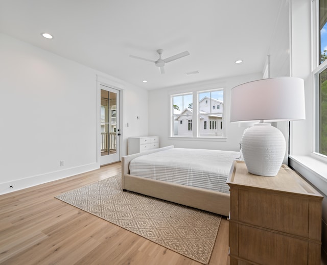 bedroom featuring access to exterior, ceiling fan, and hardwood / wood-style flooring